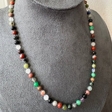 Load image into Gallery viewer, A beaded necklace made of polished multicoloured gemstone beads displayed on a grey fabric jewellery bust.