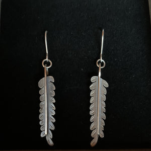 Fronds Earrings displayed in branded box